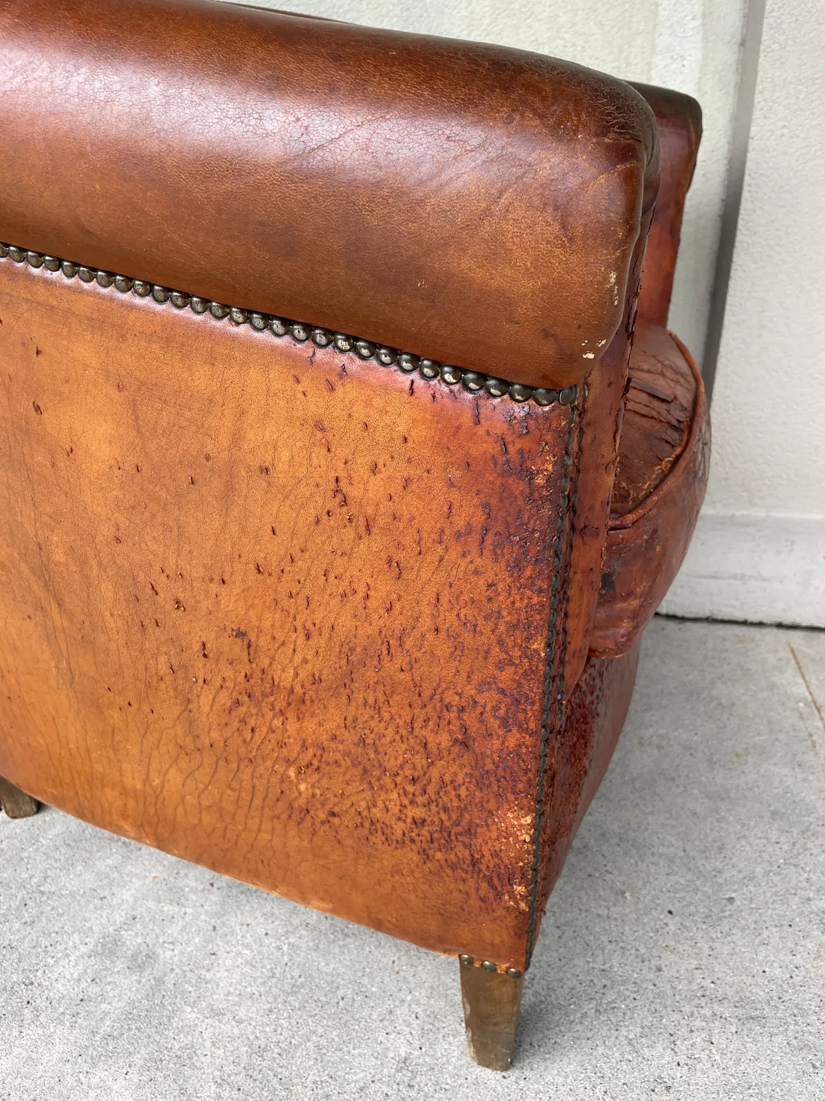 Pair Distressed Vintage European Leather Tub Chairs with Brass Nailhead Detail