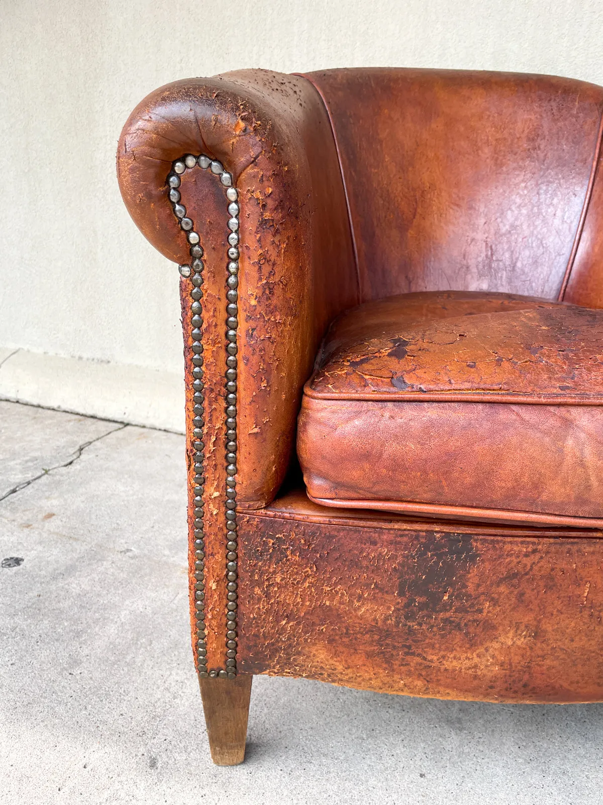 Pair Distressed Vintage European Leather Tub Chairs with Brass Nailhead Detail