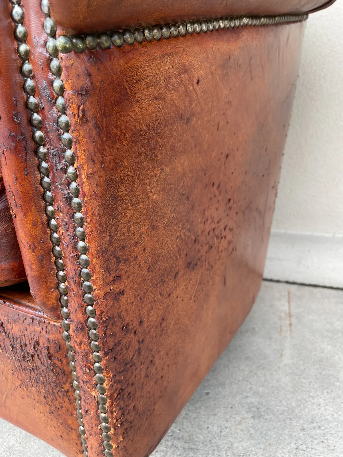 Pair Distressed Vintage European Leather Tub Chairs with Brass Nailhead Detail