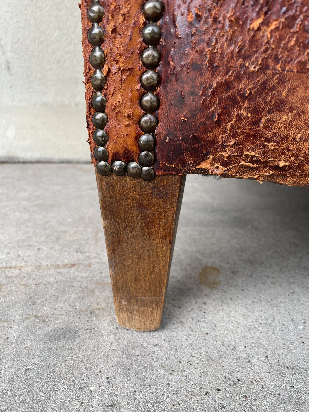 Pair Distressed Vintage European Leather Tub Chairs with Brass Nailhead Detail