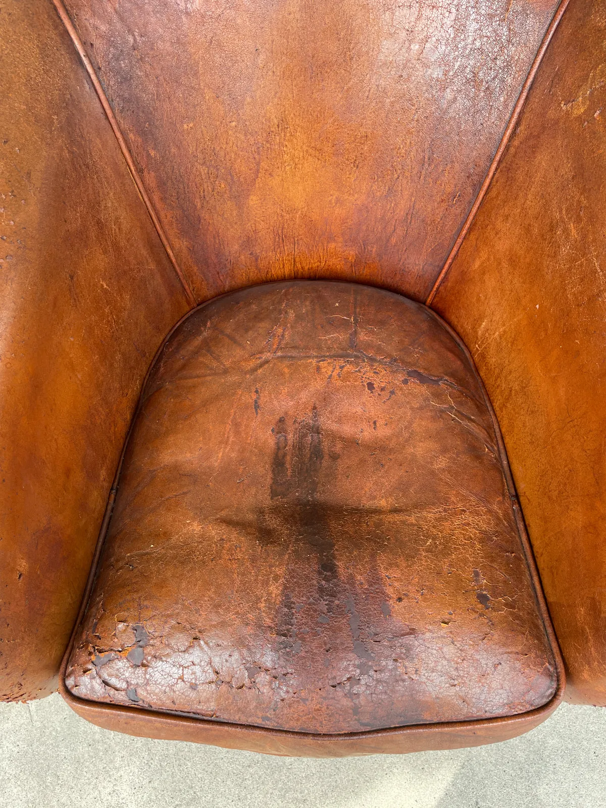 Pair Distressed Vintage European Leather Tub Chairs with Brass Nailhead Detail