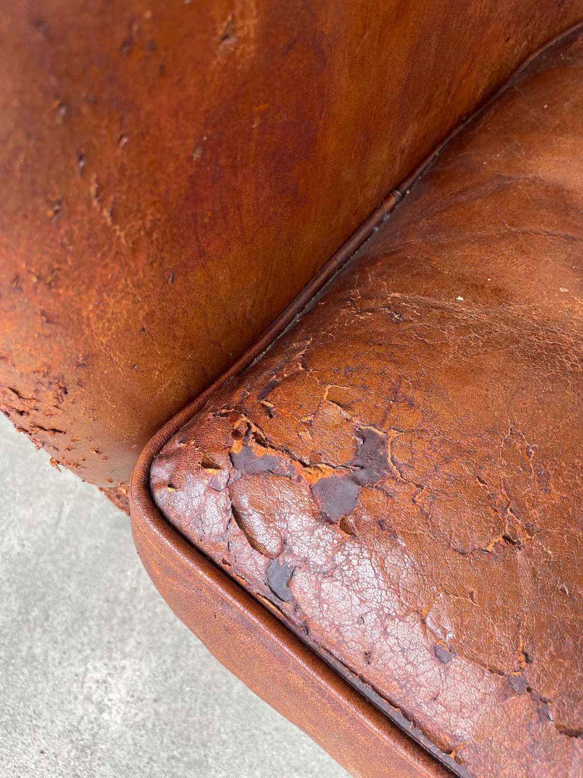 Pair Distressed Vintage European Leather Tub Chairs with Brass Nailhead Detail