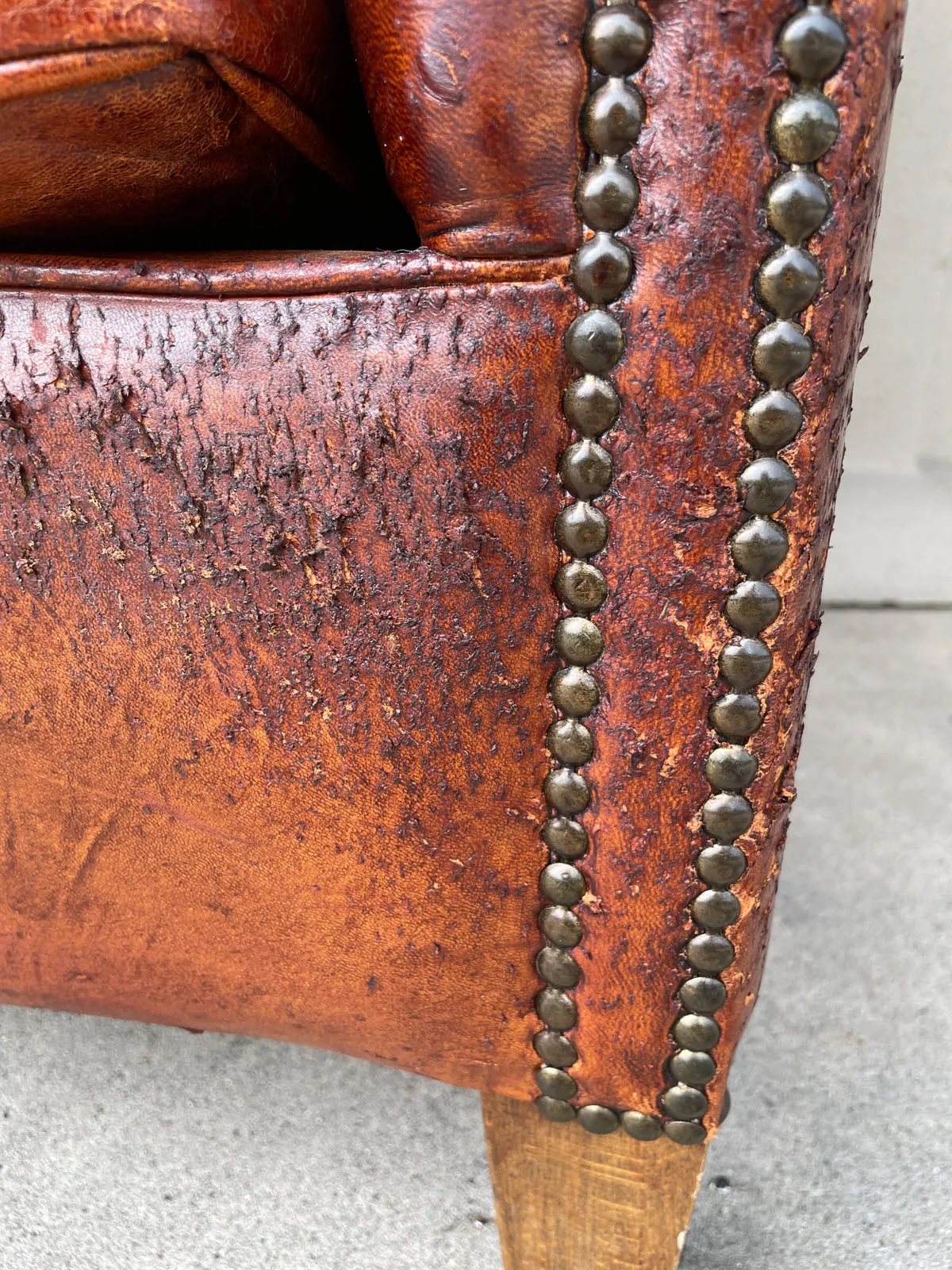 Pair Distressed Vintage European Leather Tub Chairs with Brass Nailhead Detail
