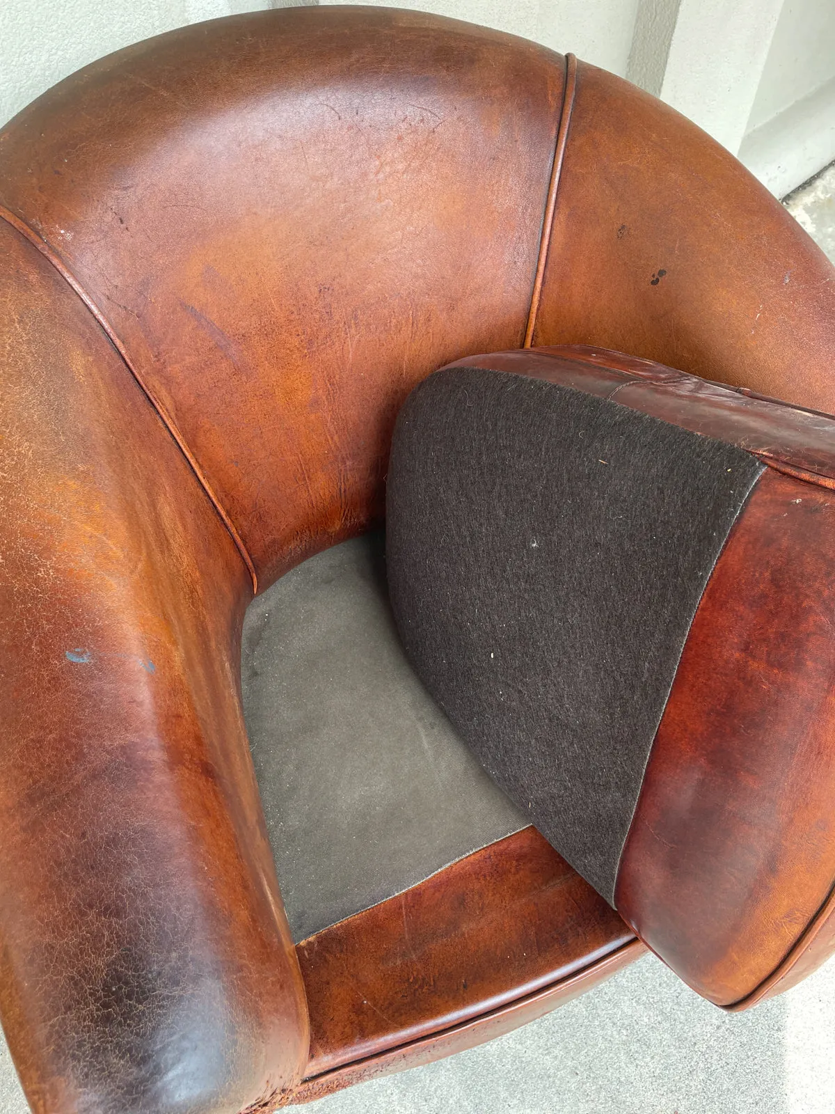 Pair Distressed Vintage European Leather Tub Chairs with Brass Nailhead Detail