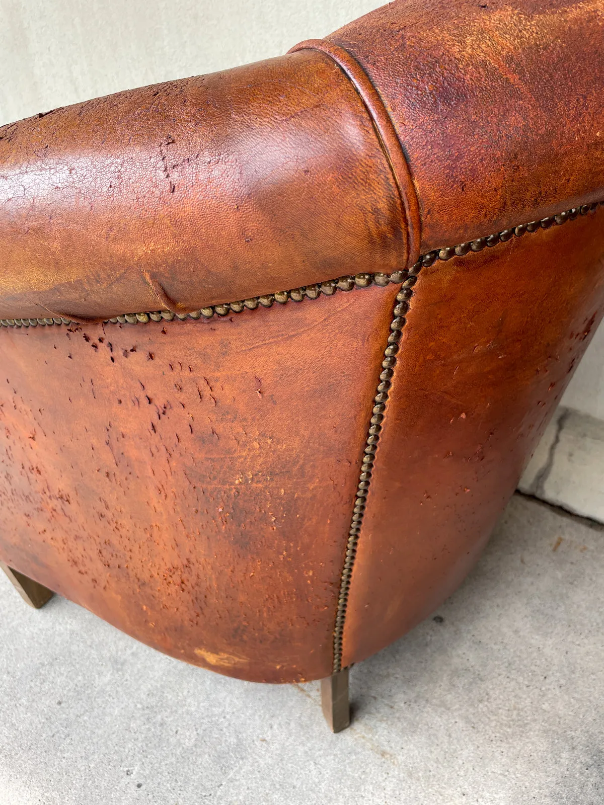 Pair Distressed Vintage European Leather Tub Chairs with Brass Nailhead Detail