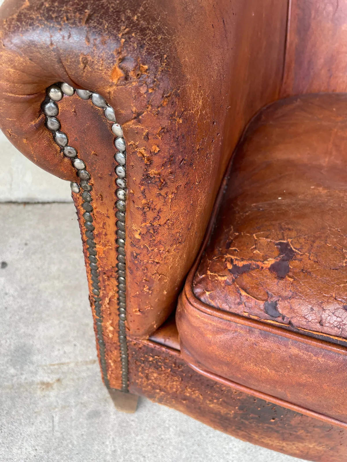 Pair Distressed Vintage European Leather Tub Chairs with Brass Nailhead Detail